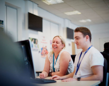 Student on a computer with lecturer