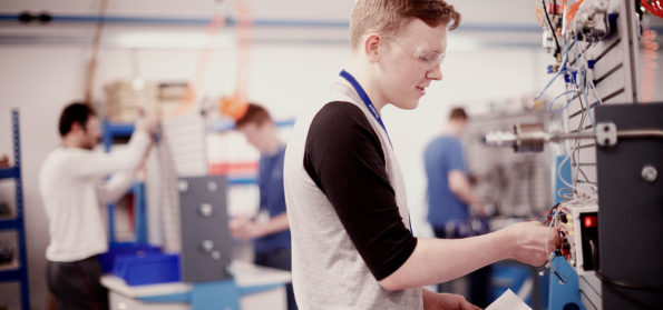T Level student in the workshop using mechanical tools.